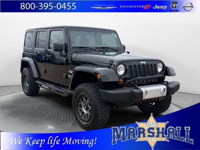 2011 Jeep Wrangler Unlimited Sahara in Black Clearcoat — front three-quarter view